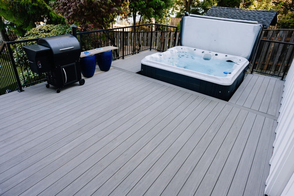 horizontal steel rod railing on composite decking with built in jacuzzi hot tub