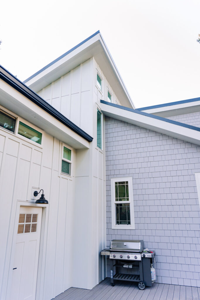 contrasting white board and batten panel and grey Hardie shake siding