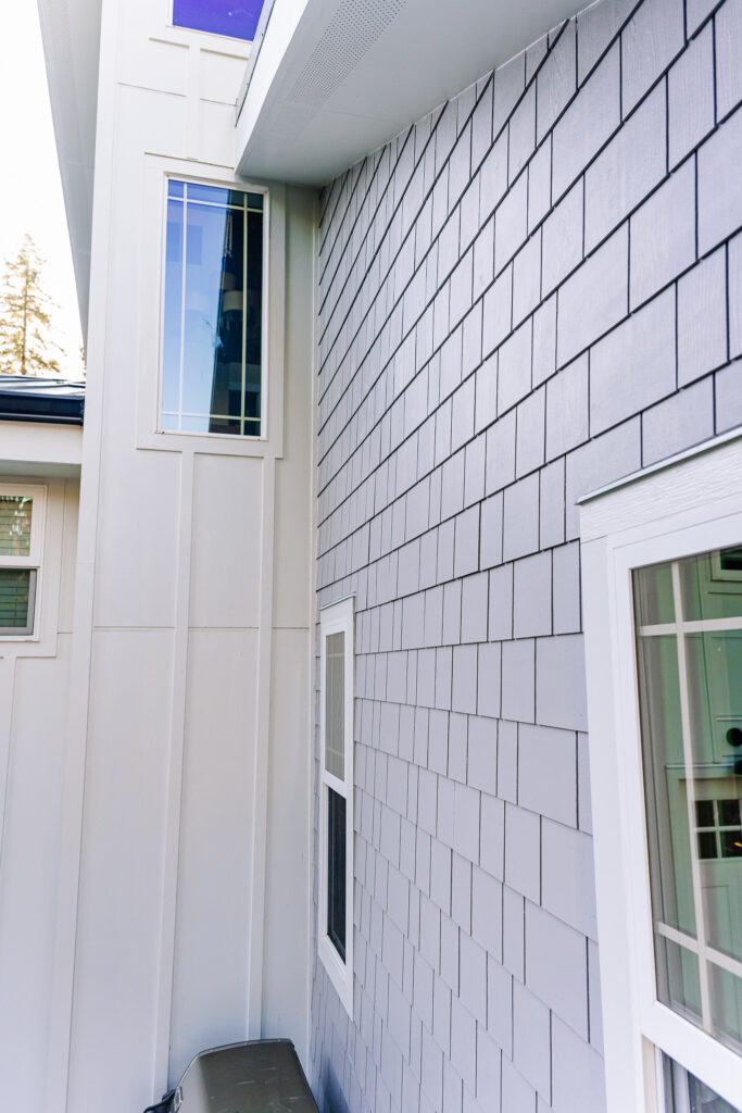 contrasting white board and batten panel and grey Hardie shake siding