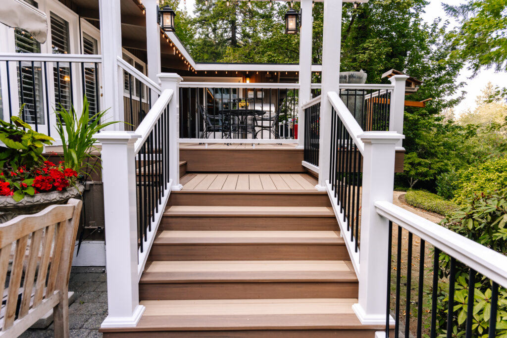 Vertical surface mount black post white rail composite railing with two tone Azek Decking