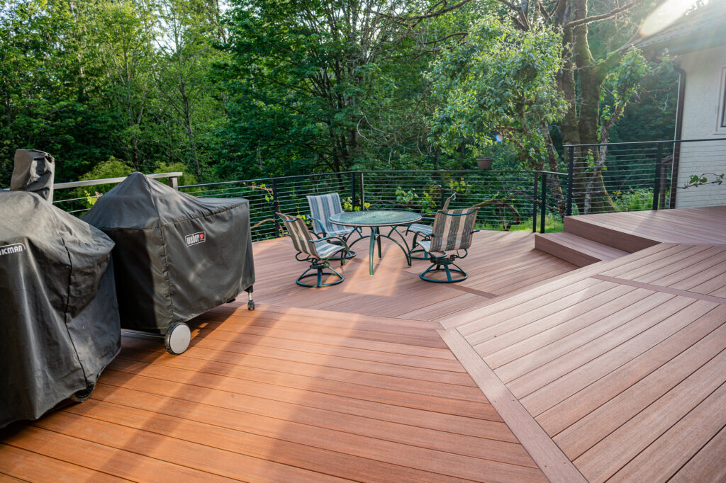 Brown composite decking with matte black fascia mounted cable railing