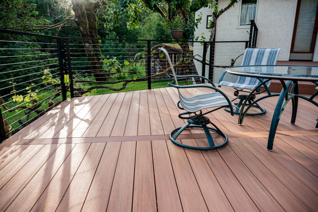 Brown composite decking with matte black fascia mounted cable railing